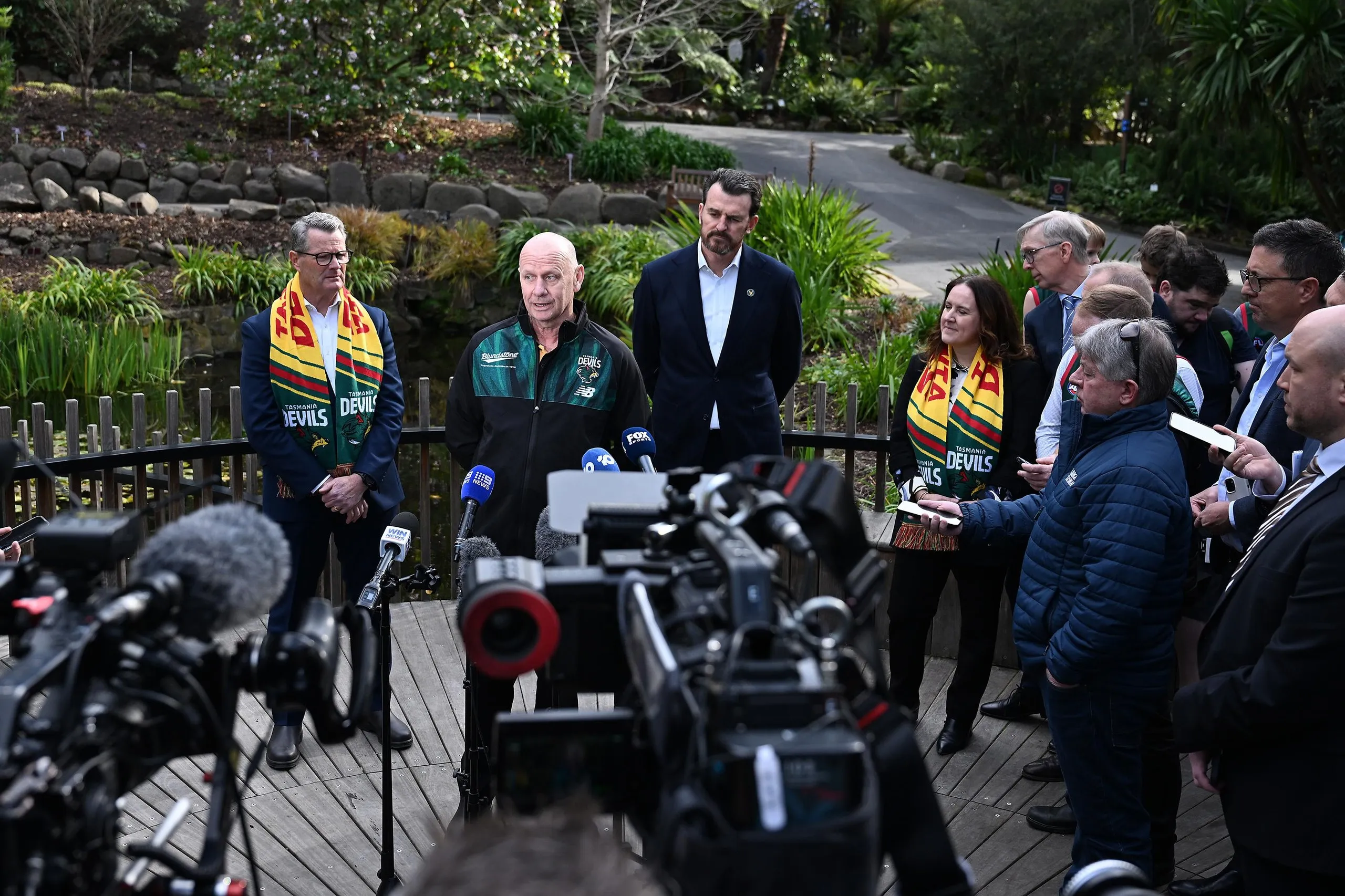 Ken Hinkley speaks to journalists and camera crews in the botanic gardens